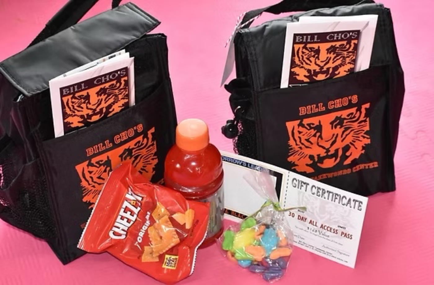 Bill Cho's UTC party favor kit — tiger logo lunch tote, gift certificate, snacks, and goody bag