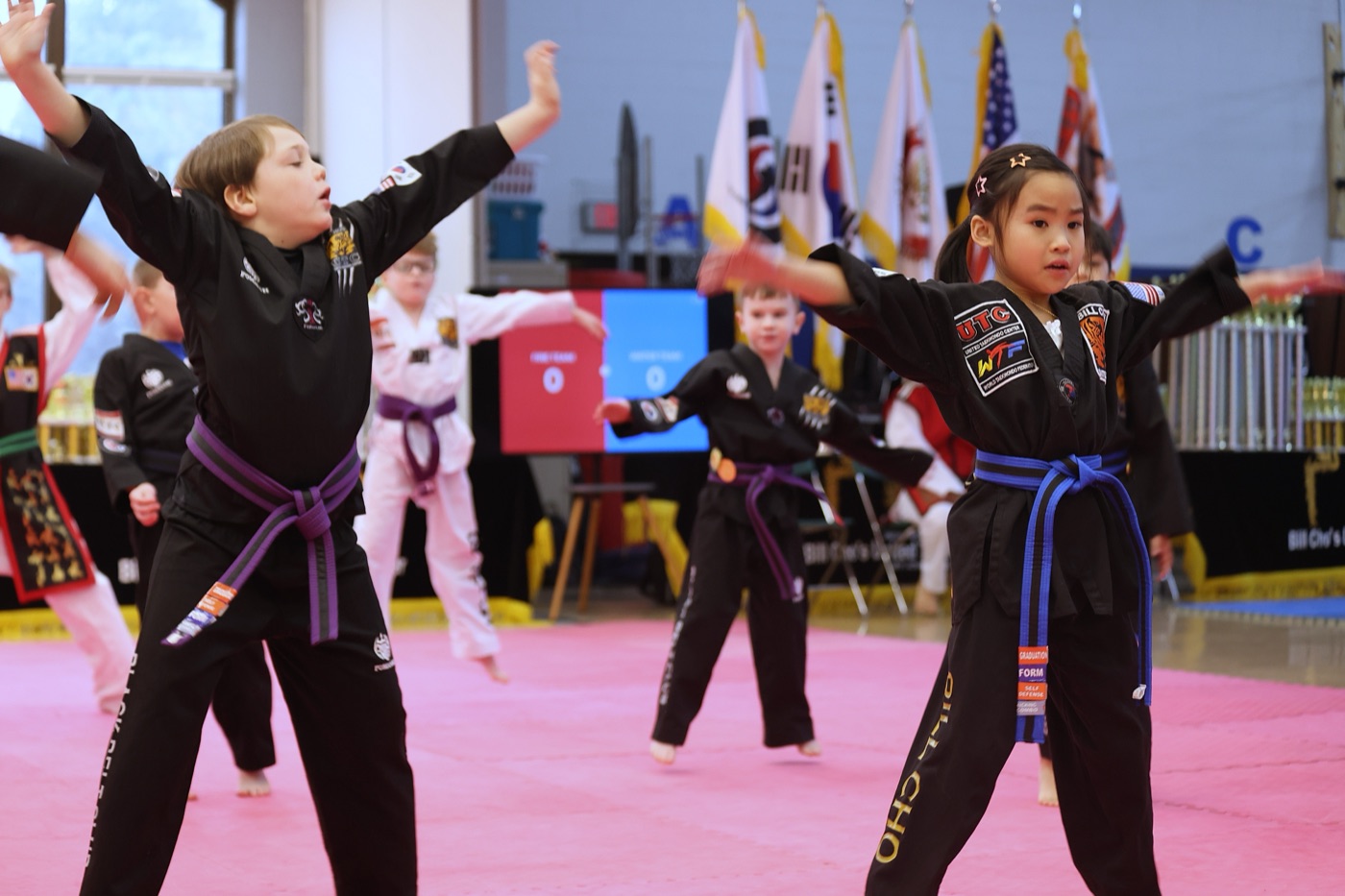 Bill Cho's Black Belt Club students in their special BBC doboks performing forms together